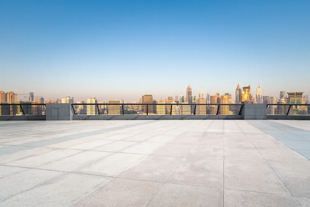 Flat rooftop with a city skyline at sunrise