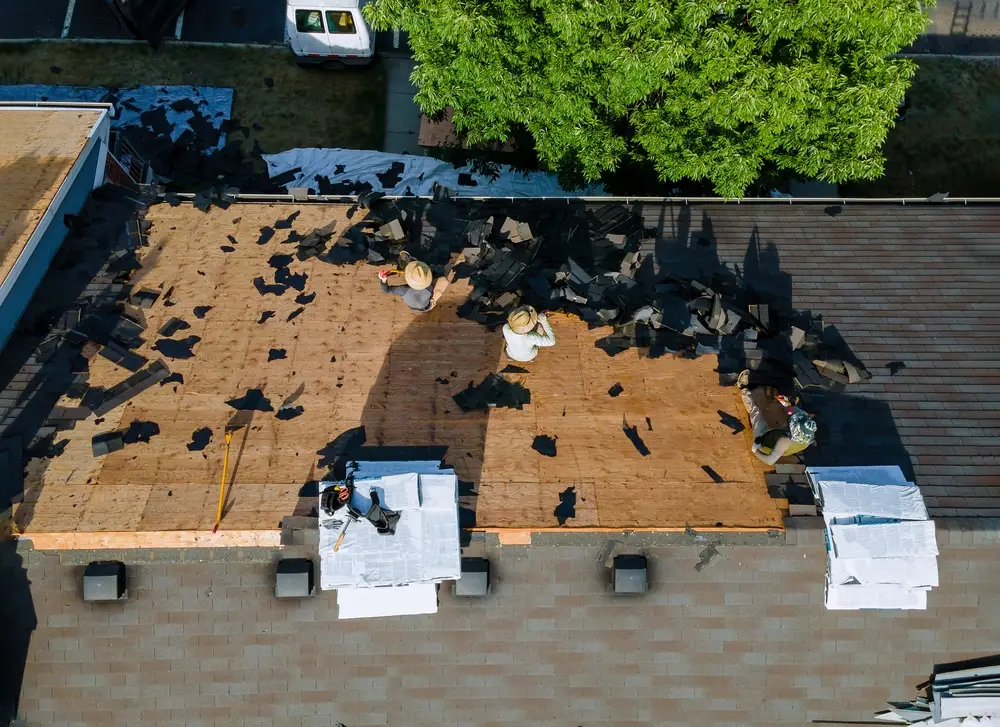 Roofing crew installing a new roof on a house