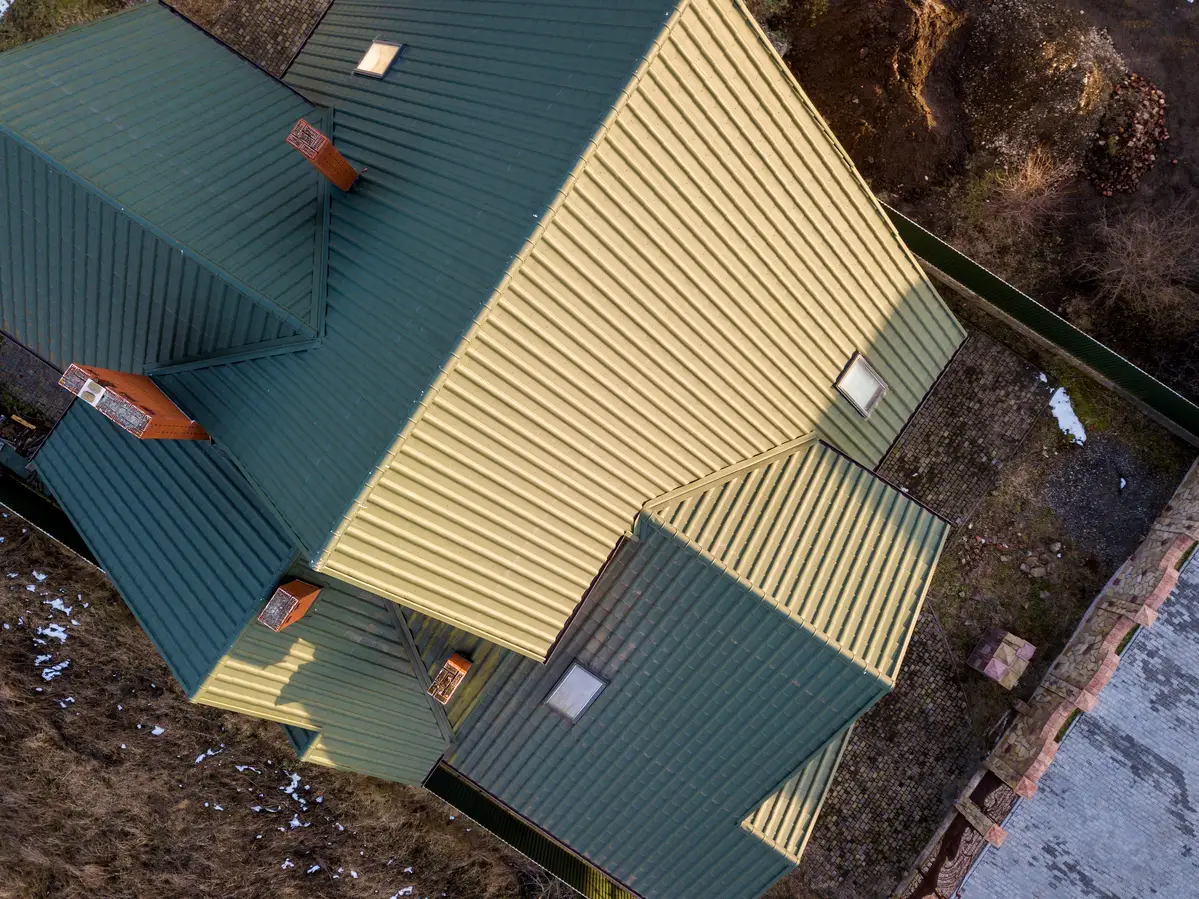 Aerial view of homes with green and gray roofs