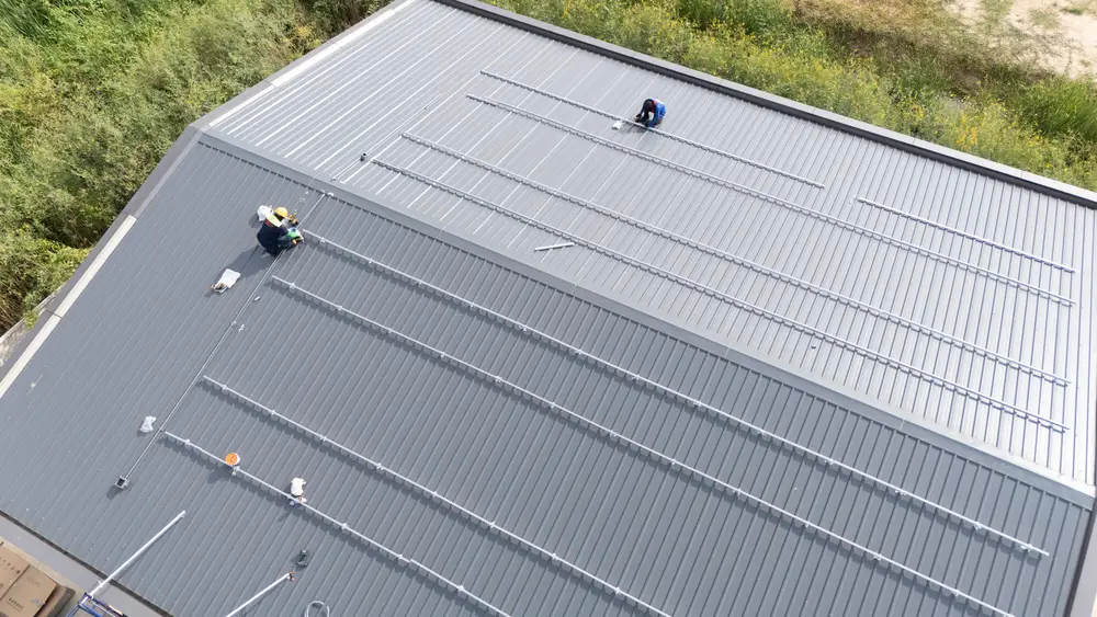 Workers installing a metal roof