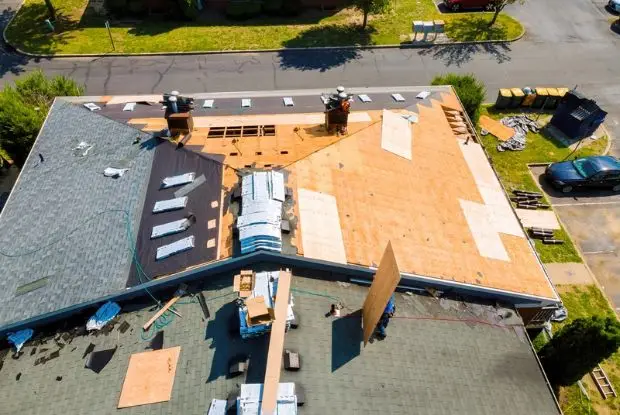 Aerial view of a roof replacement with the decking exposed