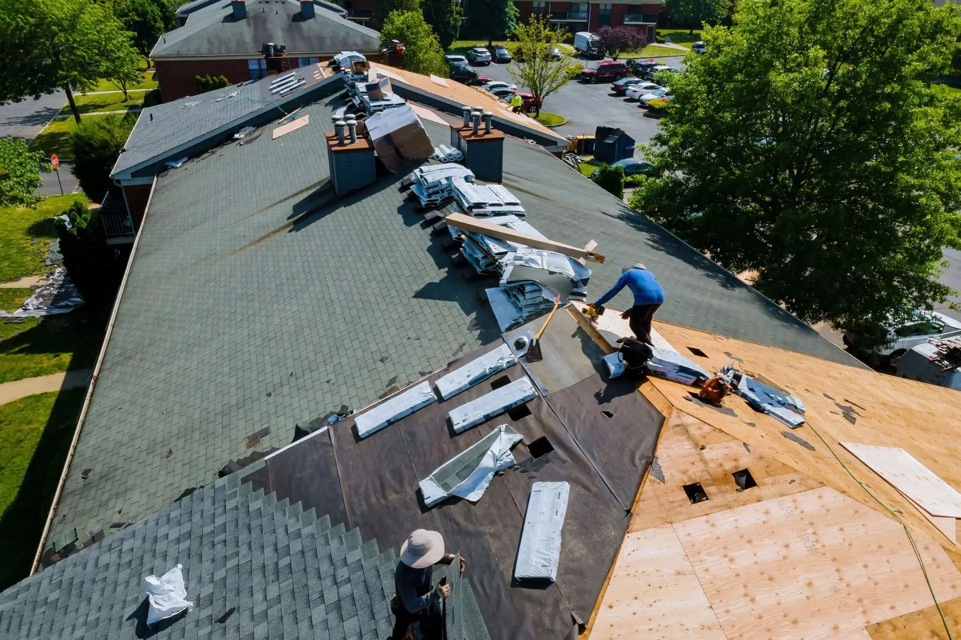 Aerial view of roofers replacing shingles