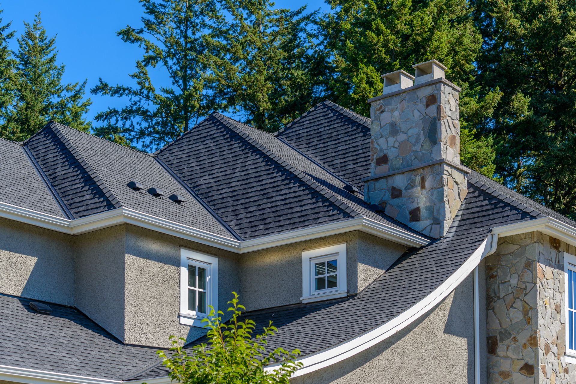 Two-story house with gray shingle roofs