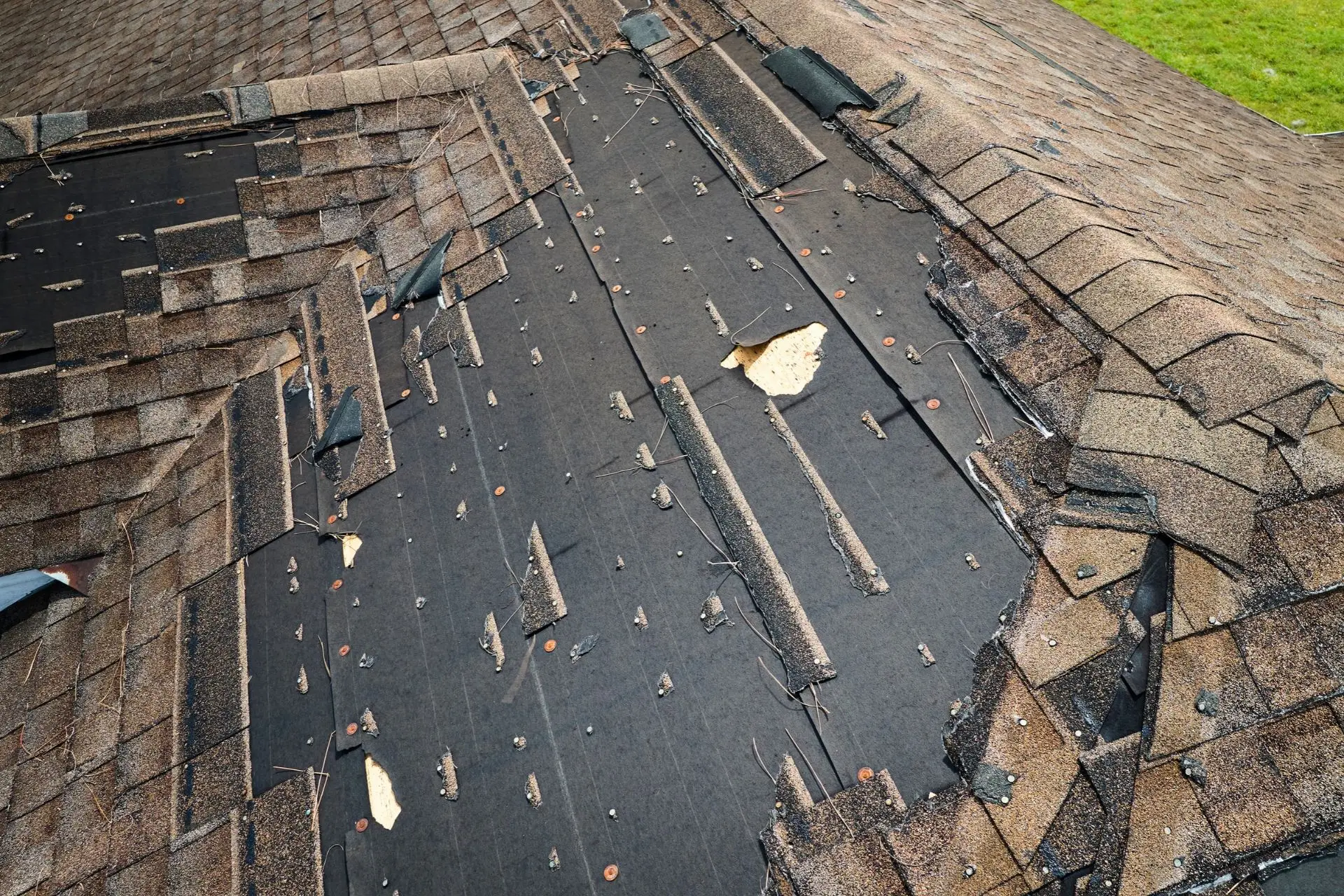 Close-up of damaged and missing asphalt shingles