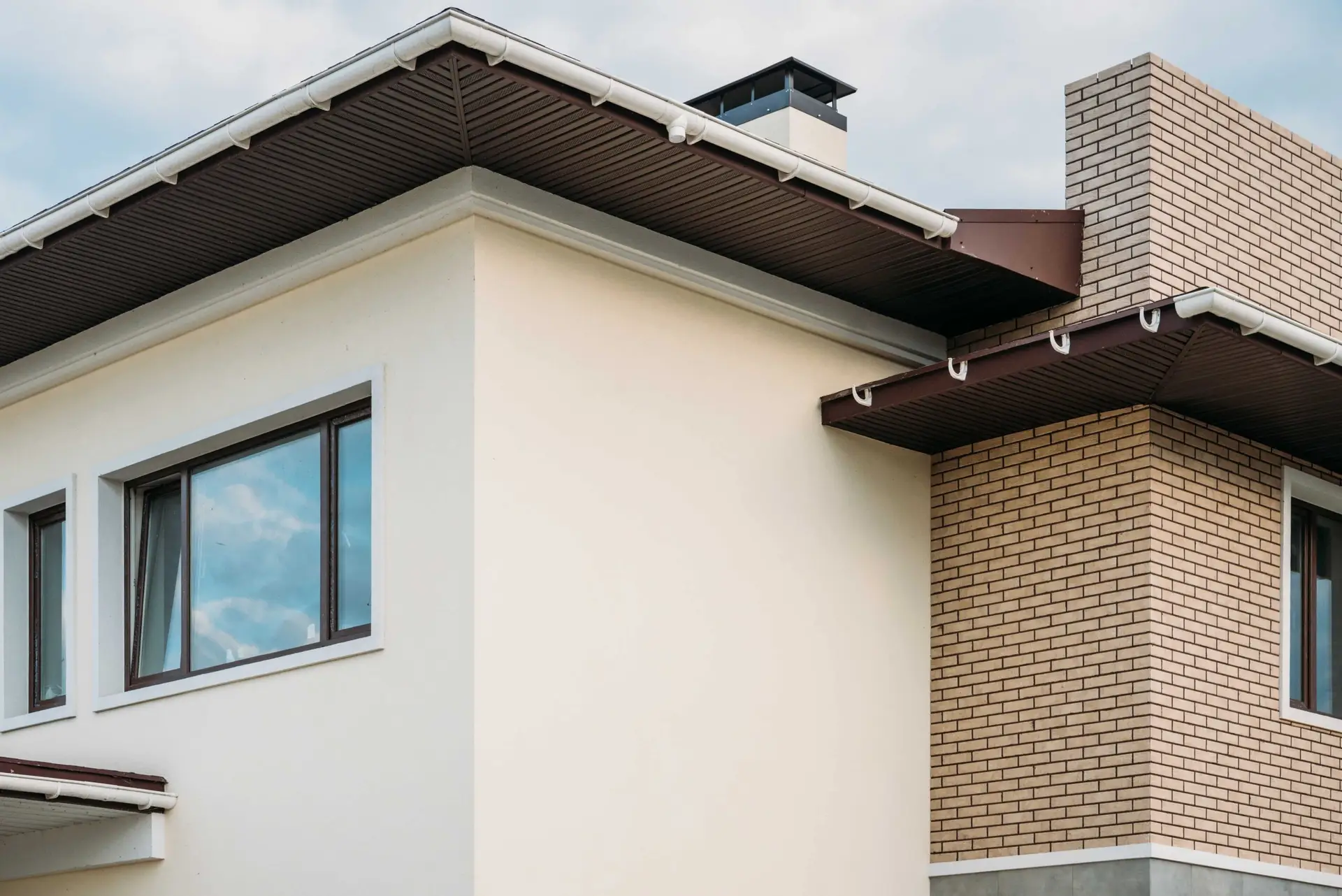 Two-story house with fresh exterior paint and brick accents