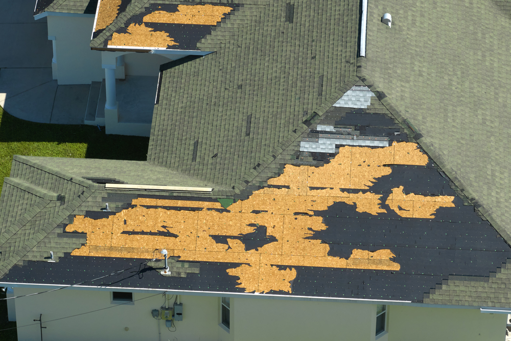 Roof with missing shingles after storm damage