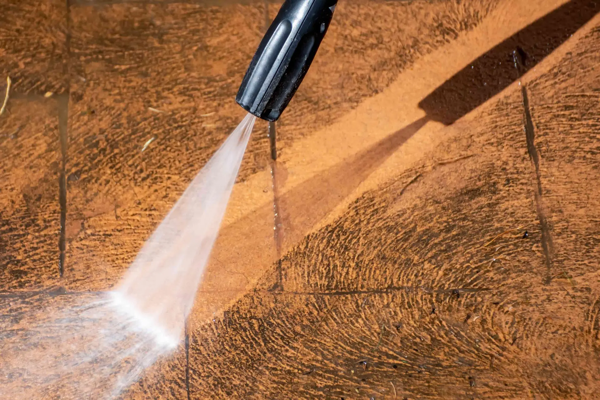 Pressure washing a dirty wood surface