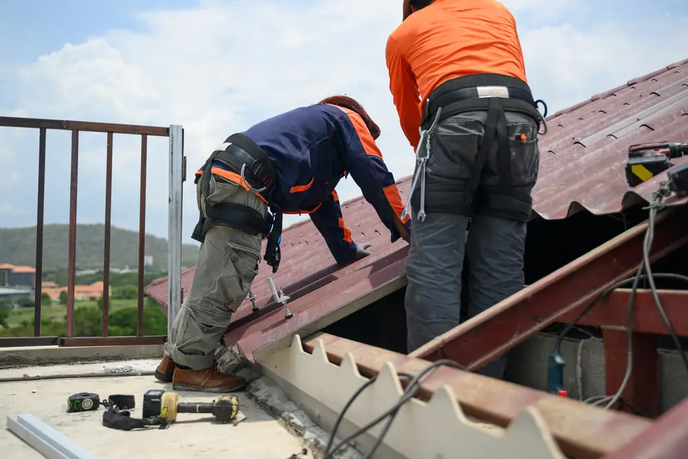 Roofers working on a metal roof