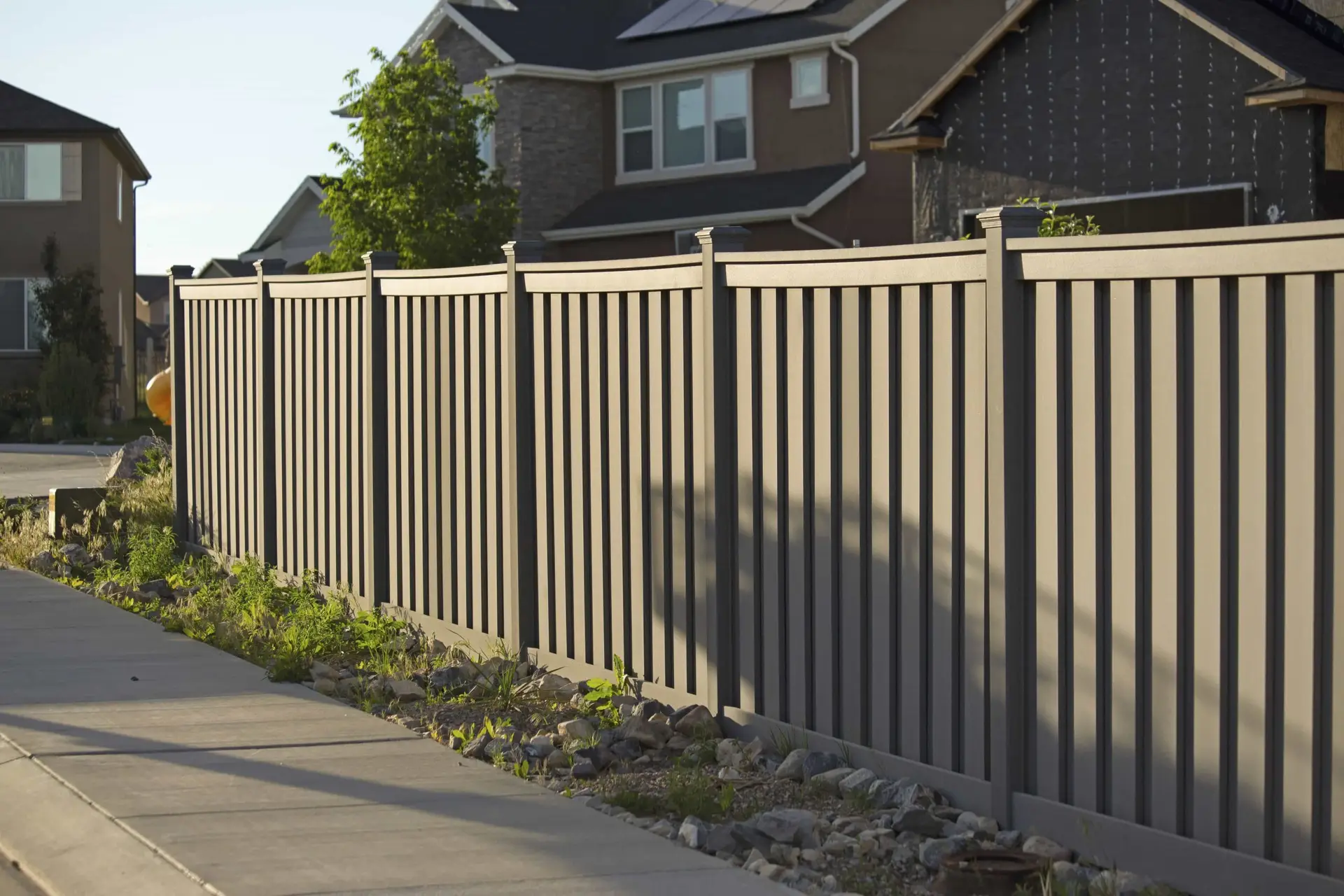 Wooden privacy fence along a sidewalk