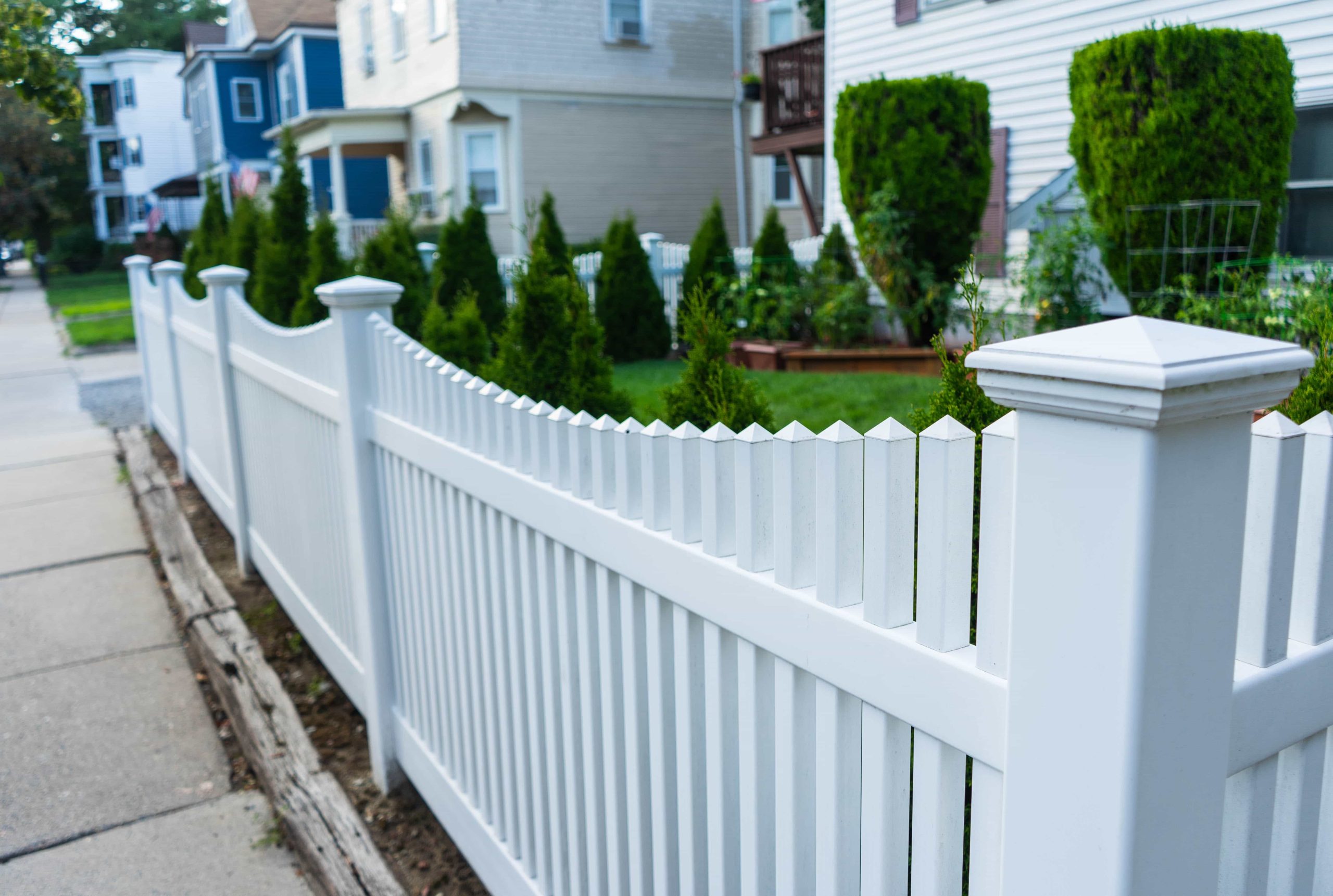 White vinyl fence with greenery